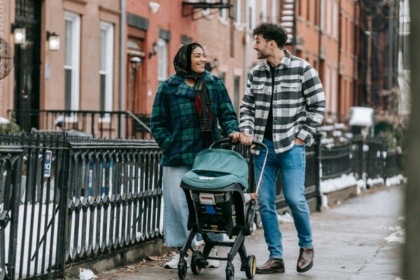 couple with baby stroller