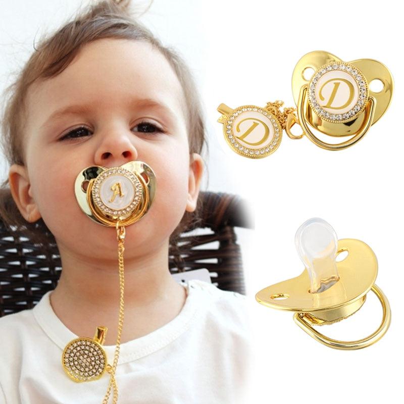 baby with golden bling pacifier